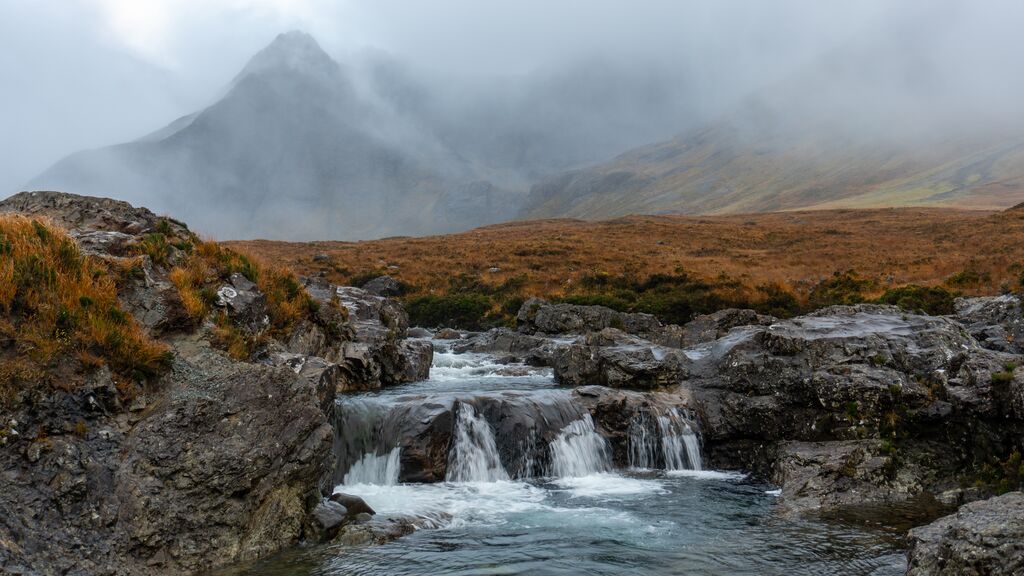 waterfalls and river streams on Isle of Skye with mountain backdrop