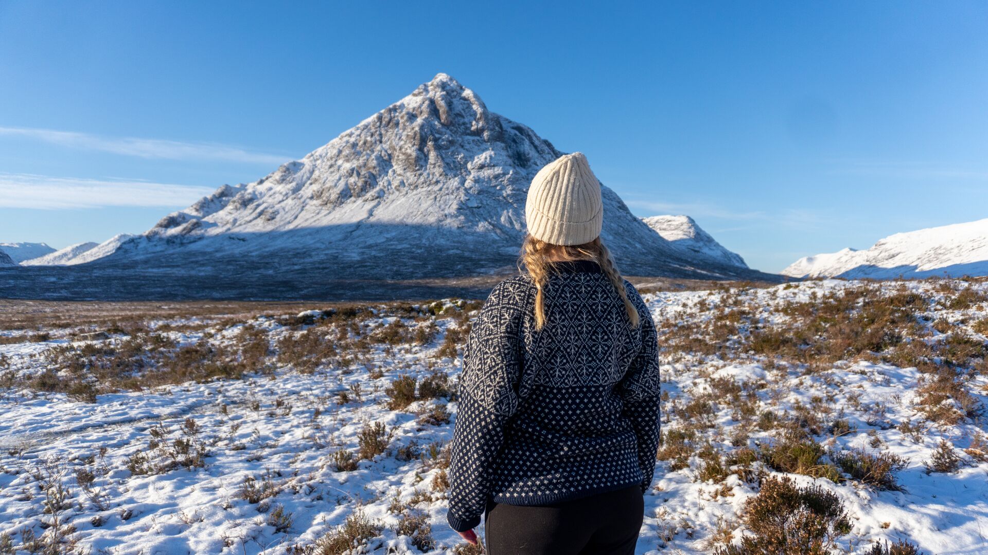Woman at Glen Coe during frosty day in sunny Highlands in Scotland