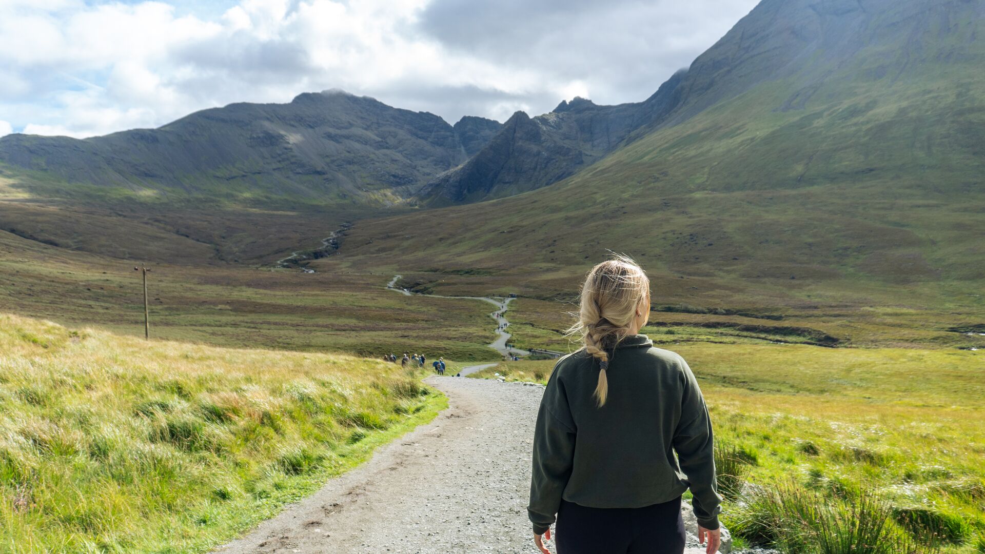 Traveller walking along Fairy Pools on Skye